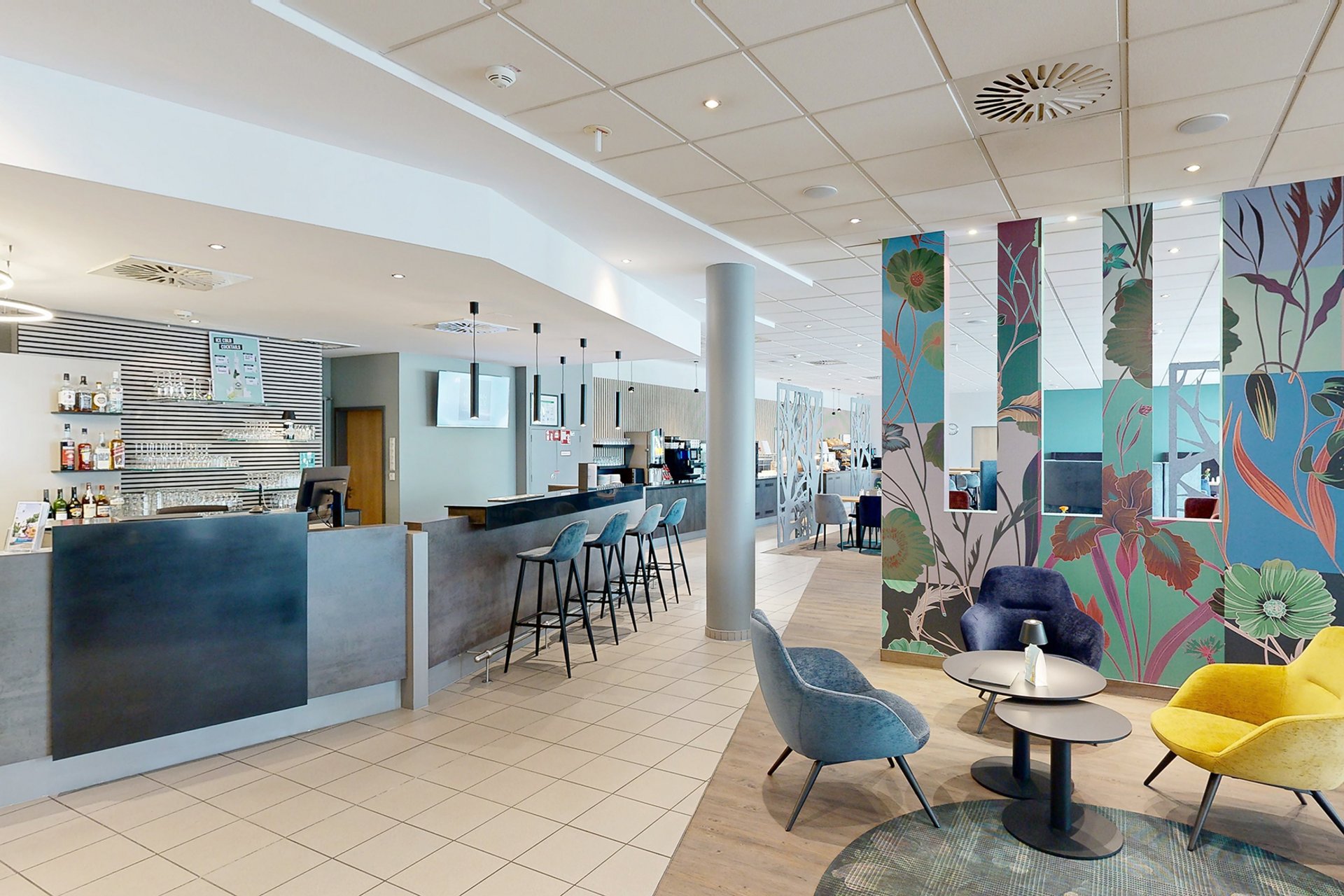 Our hotel at the exhibition centre: the picture gallery Modern hotel bar area with seating and colorful wall panels