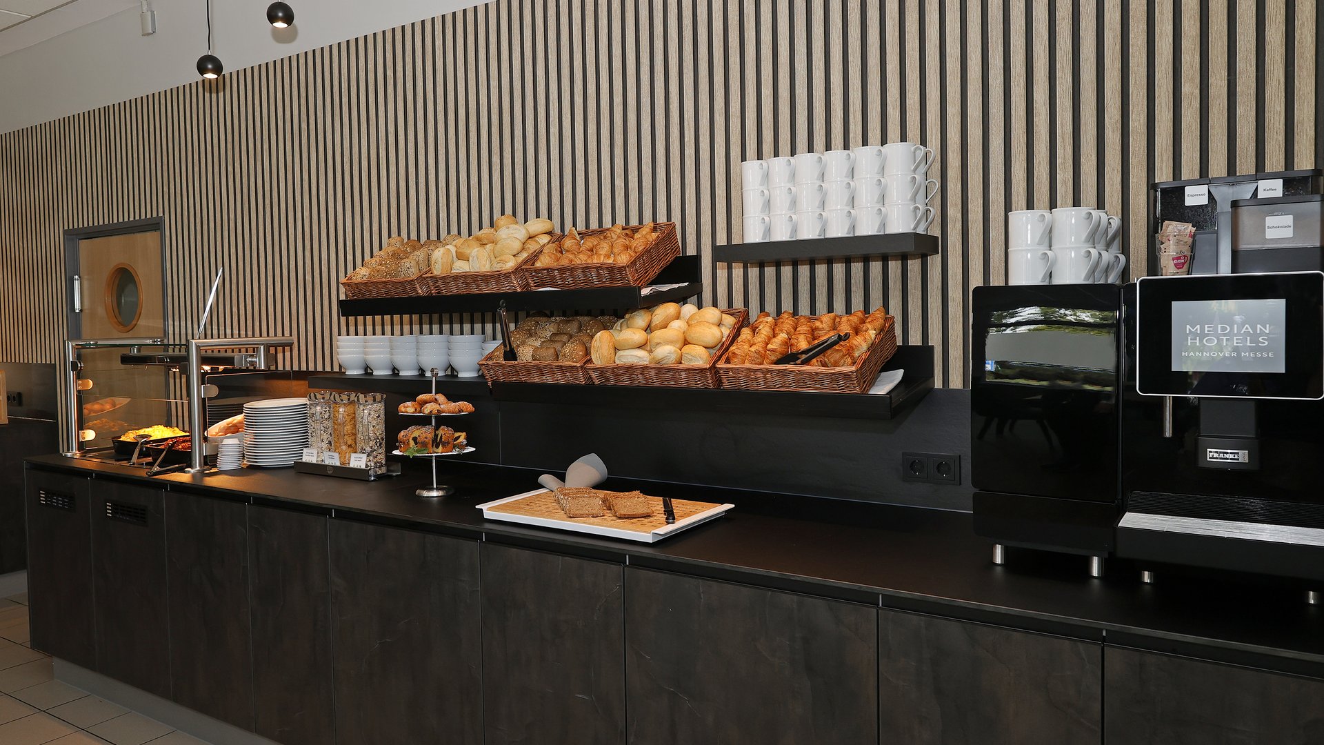 Room with breakfast in Hanover? Median Hotel! Breakfast buffet with rolls, croissants, coffee machine, and pastries in hotel