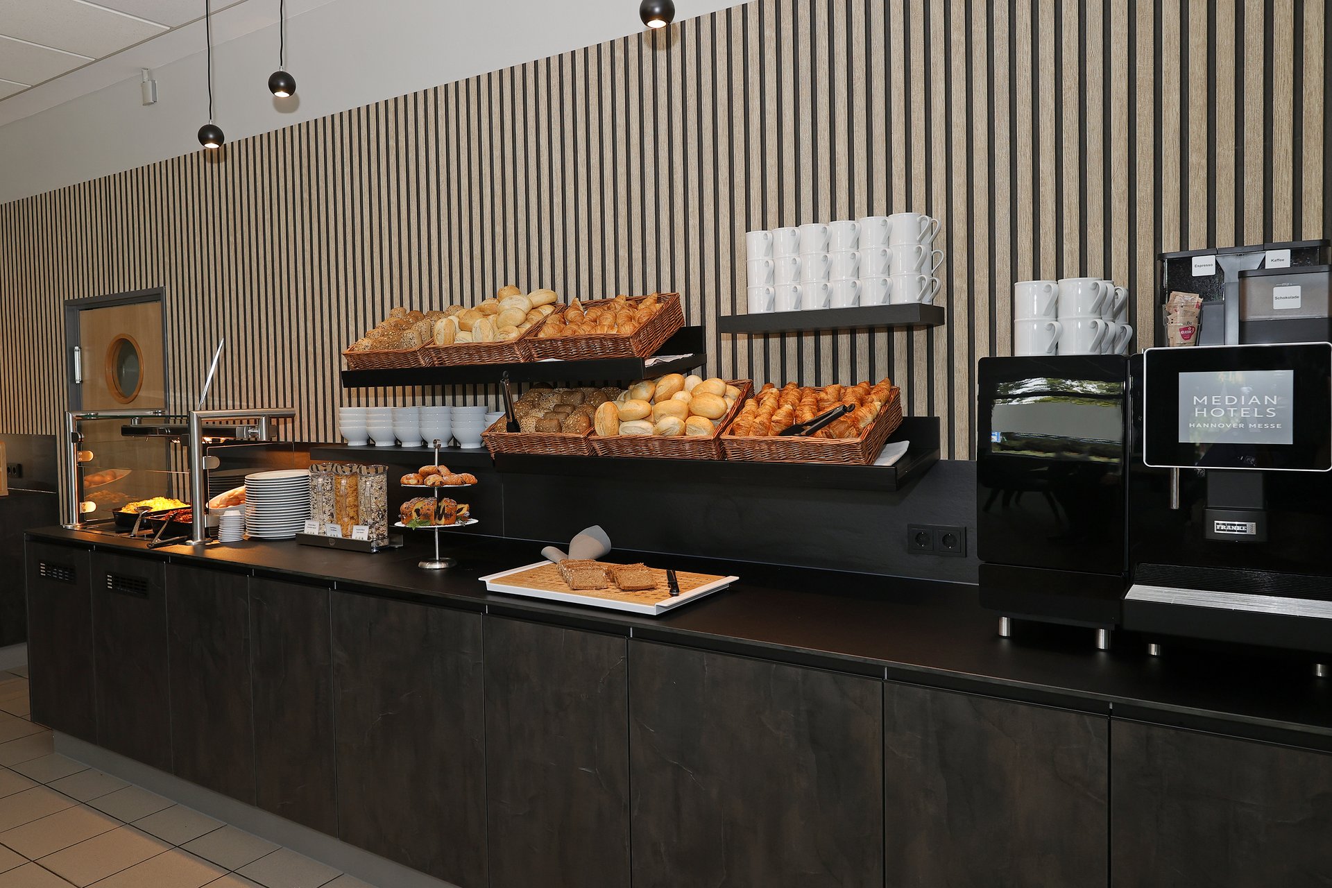 Our hotel at the exhibition centre: the picture gallery Breakfast buffet with rolls, croissants, coffee machine, and pastries in hotel