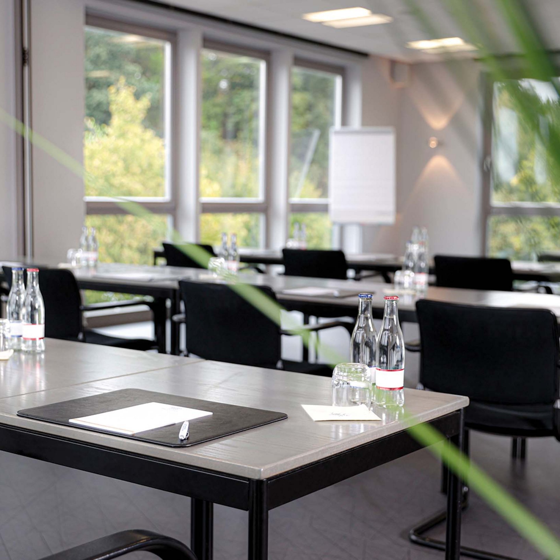 Median Hotel Hannover Lehrte Modern conference room with tables, chairs, water bottles, and notepads